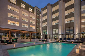 Sparkling pool and jacuzzi with cabanas